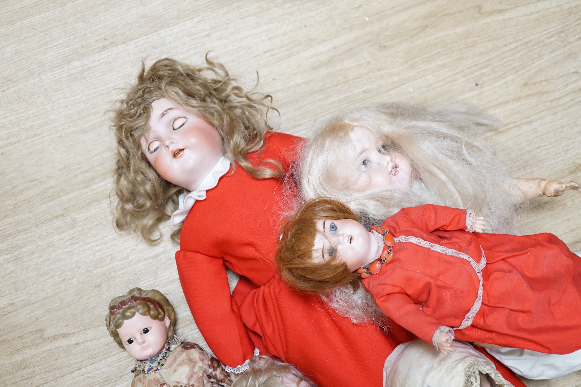 Two Kammer and Reinhardt bisque headed dolls, a wax over composition doll, various other bisque headed dolls and a few single heads and a collection of miniature dolls
